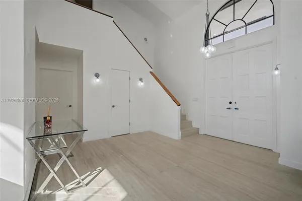 a large kitchen with granite countertop a sink stainless steel appliances and cabinets