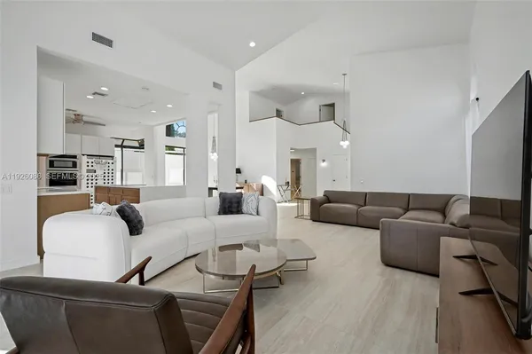 a bedroom with a bed and a flat tv screen on a dresser