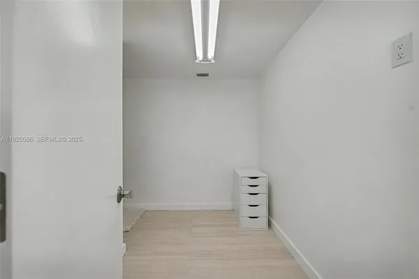 a bathroom with a shower a mirror and a shower