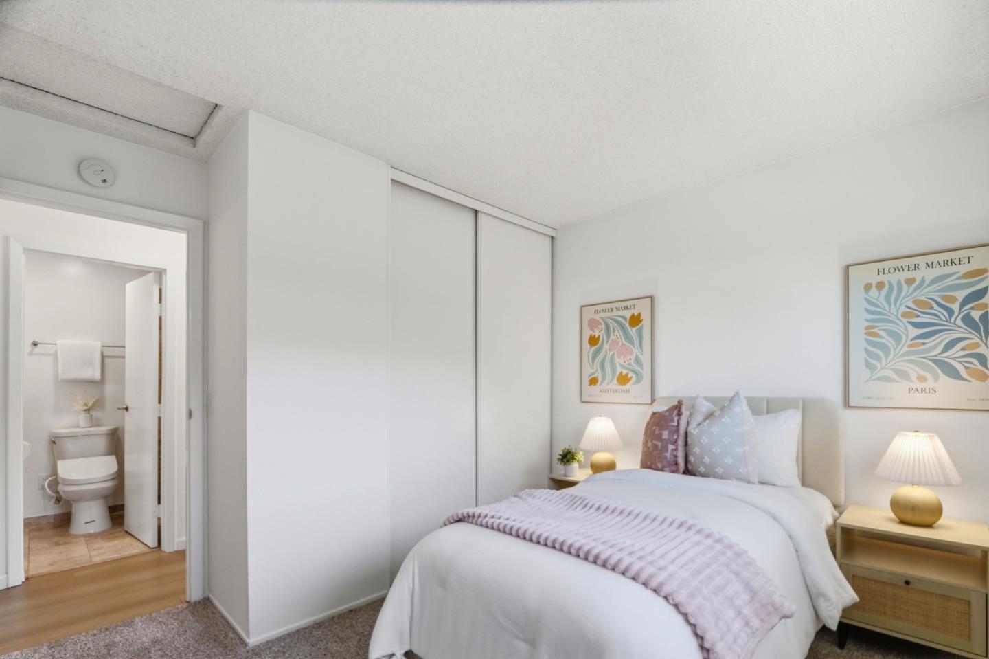 1085 Reed Avenue, Unit D Sunnyvale, CA 94086 - Photo 19 of 32 a bedroom with a bed and painting on the wall