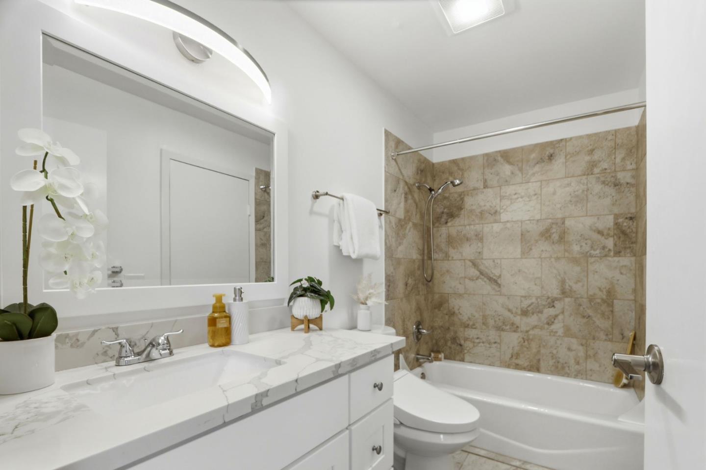 1085 Reed Avenue, Unit D Sunnyvale, CA 94086 - Photo 22 of 32 a bathroom with a granite countertop sink a toilet and a bathtub
