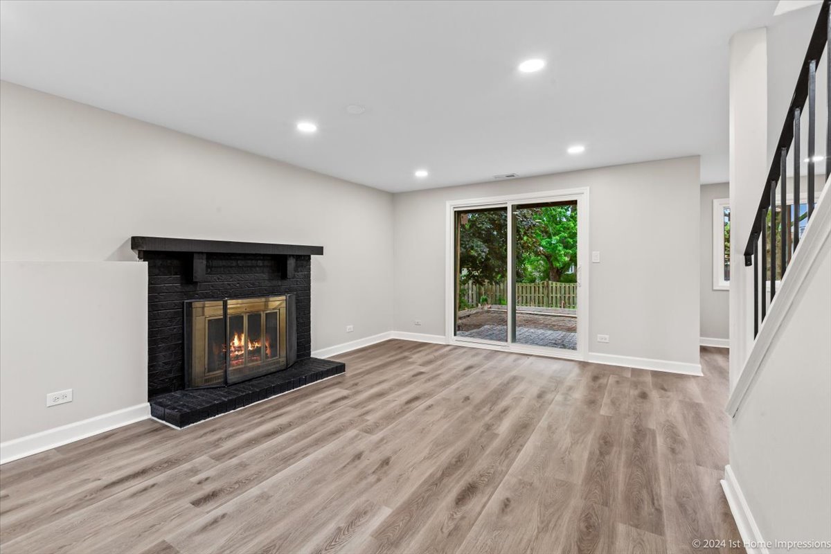 44 Wedgewood Road Matteson, IL 60443 - Photo 17 of 29 an empty room with wooden floor fire place and windows