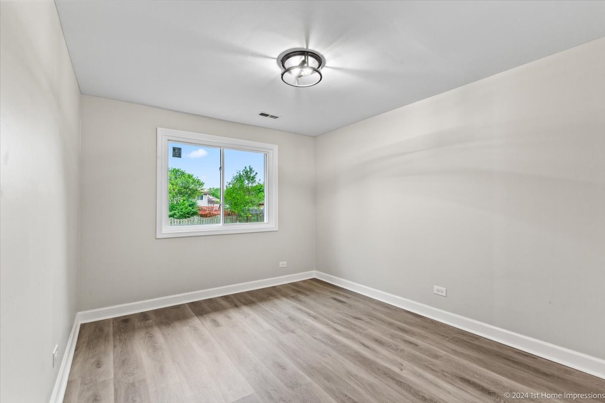 44 Wedgewood Road Matteson, IL 60443 - Photo 23 of 29 wooden floor in an empty room with a window