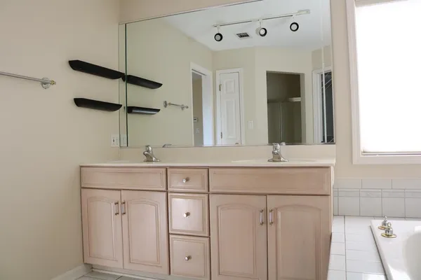 a bathroom with 2 sink and a mirror