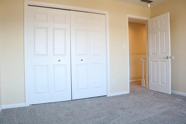 an empty room with closet area