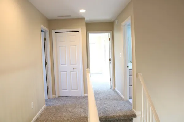 a view of a hallway with wooden shelves