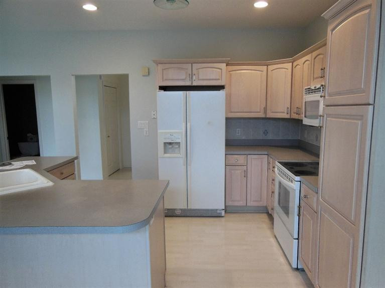 9939 Sequoia Lane Munster, IN 46321 - Photo 7 of 41 a kitchen with granite countertop a refrigerator and a sink