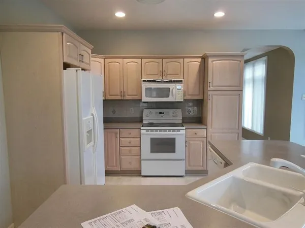 a kitchen with a sink cabinets and stainless steel appliances