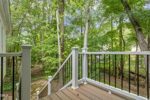 a view of a house with backyard and trees