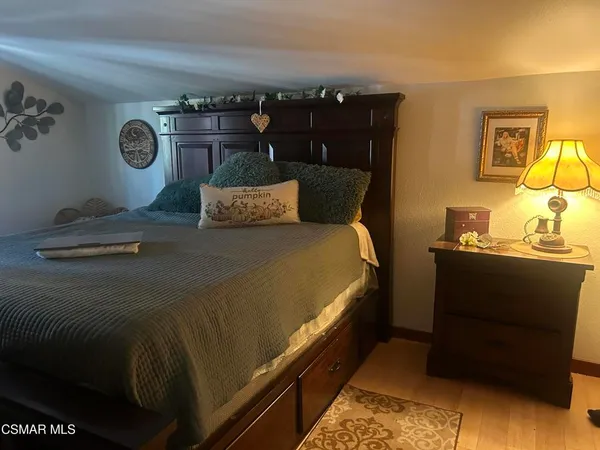 a bed sitting in a bedroom next to a lamp