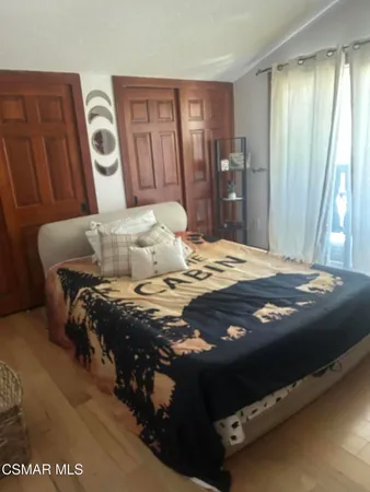 a bedroom with a bed and a mirror