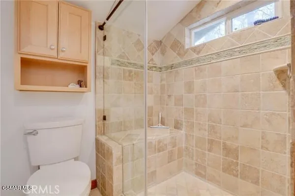 a bathroom with a toilet and shower