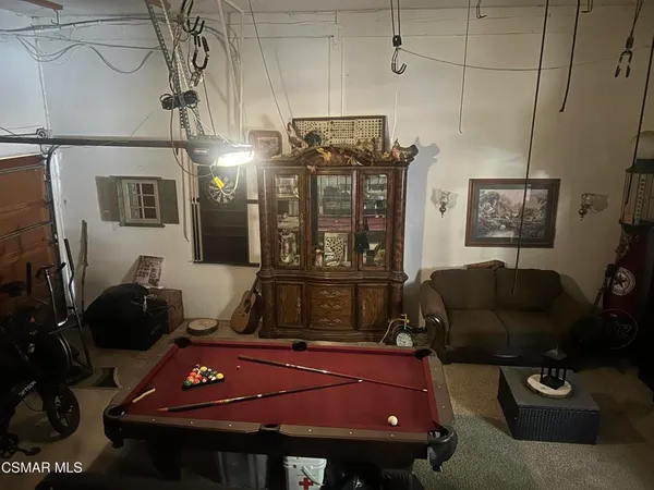 a living room with furniture a flat screen tv and a window