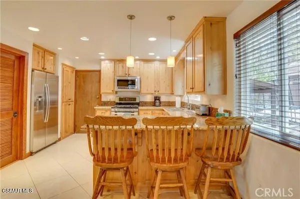 a large kitchen with a table and chairs