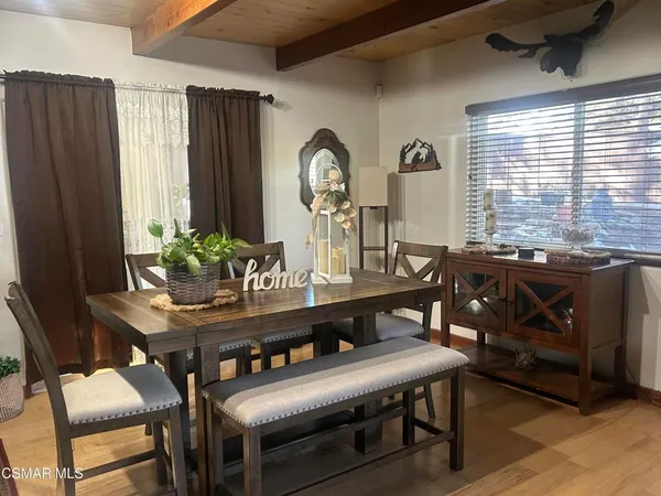 a view of a dining room with furniture and window