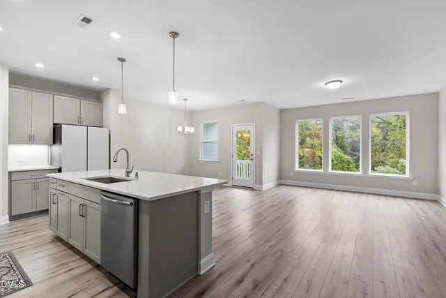 a kitchen with stainless steel appliances a sink stove and cabinets