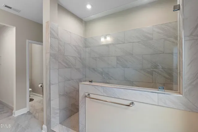 a bathroom with a bathtub and a shower