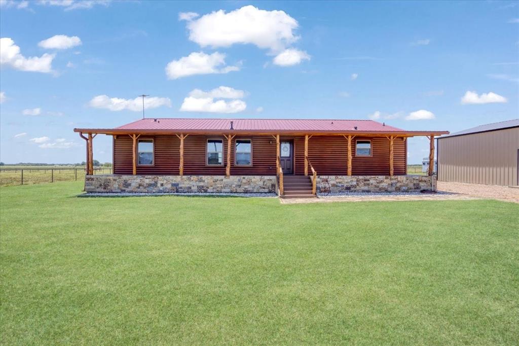 2290 Brooks Lane Sadler, TX 76264 - Photo 1 of 36 a front view of a house with a big yard and potted plants