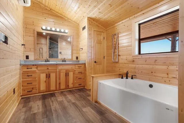 a bathroom with a sink a mirror and a bathtub