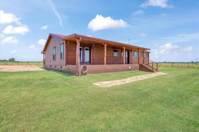a view of a house with a yard and sitting area