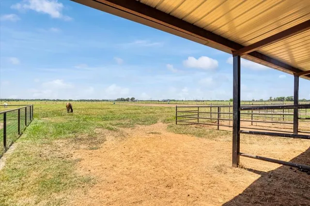 a view of a house with a backyard and a patio