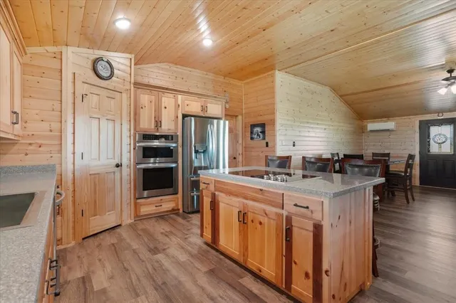 a kitchen with stainless steel appliances granite countertop a stove and refrigerator