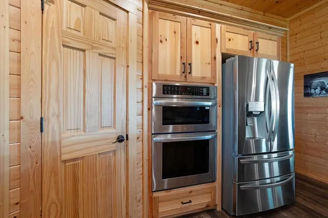 a metallic refrigerator freezer sitting in a kitchen
