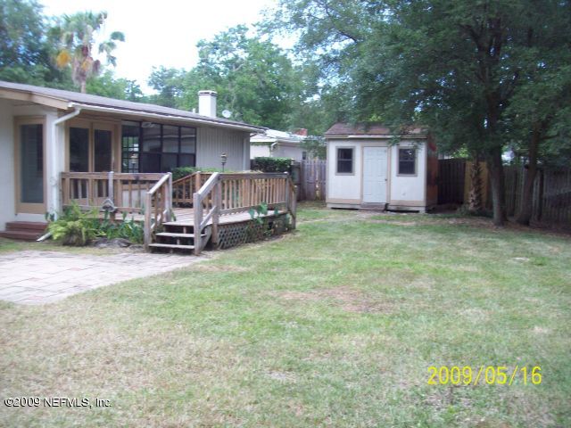 1740 Furman Road Jacksonville, FL 32217 - Photo 7 of 7 a view of a backyard with a small cabin and wooden fence