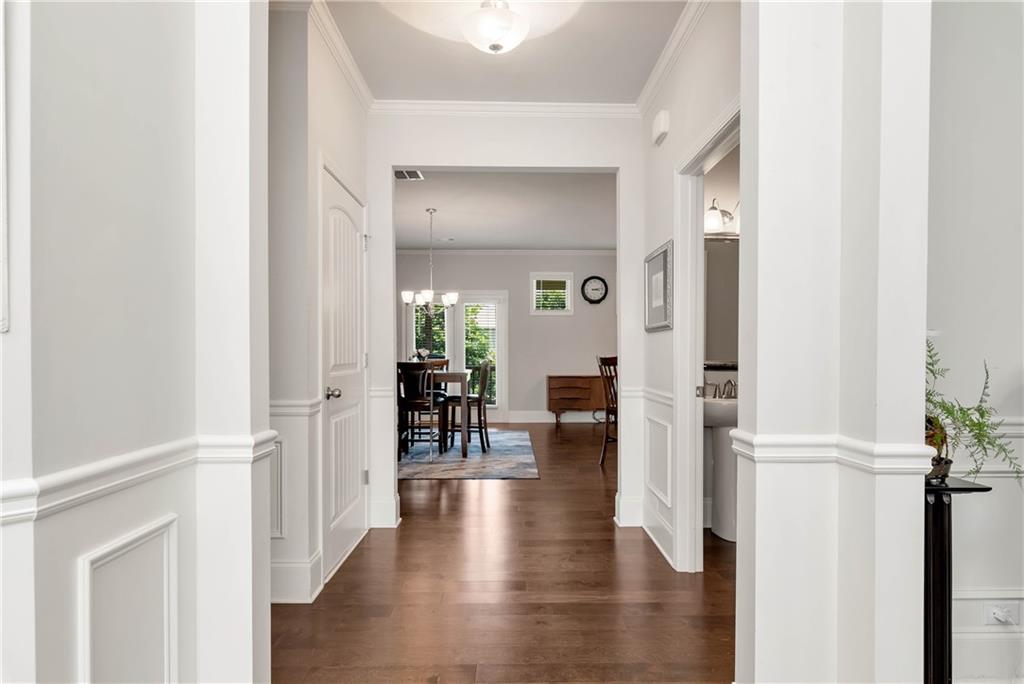 a view of a hallway with wooden floor windows and a livingroom