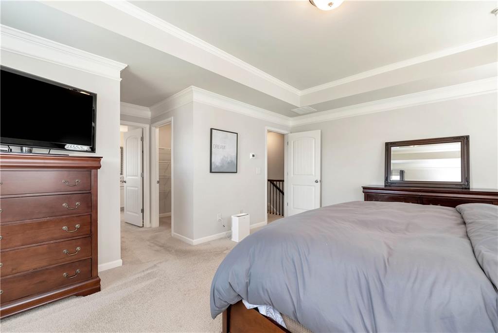 253 Orchard Trail Canton, GA 30115 - Photo 17 of 40 a bedroom with a bed and a flat screen tv