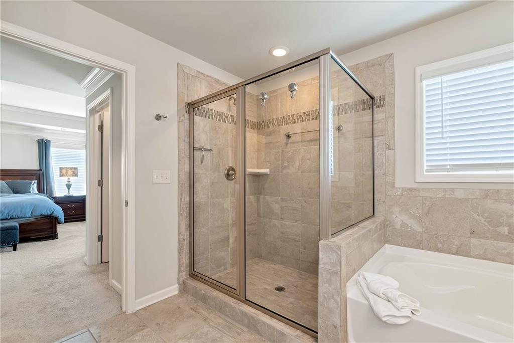 253 Orchard Trail Canton, GA 30115 - Photo 20 of 40 a bathroom with a shower and a bathtub