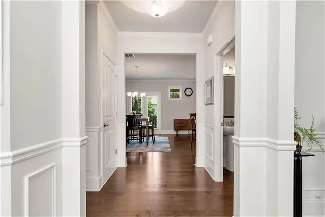 a view of a hallway with wooden floor windows and a livingroom