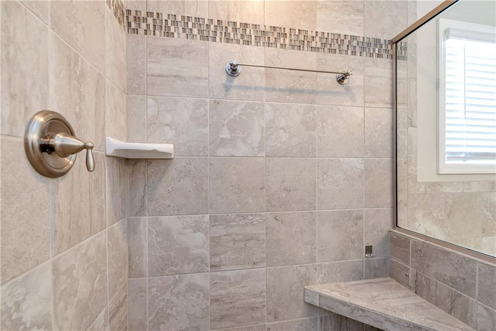 253 Orchard Trail Canton, GA 30115 - Photo 21 of 40 a bathroom with a tub and a shower