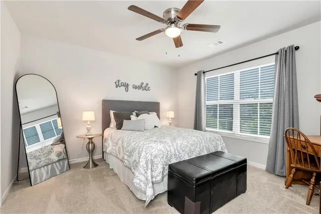 a bedroom with a bed couch and a window