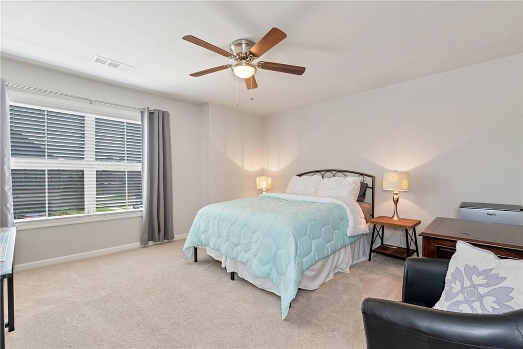 253 Orchard Trail Canton, GA 30115 - Photo 24 of 40 a spacious bedroom with a bed and window
