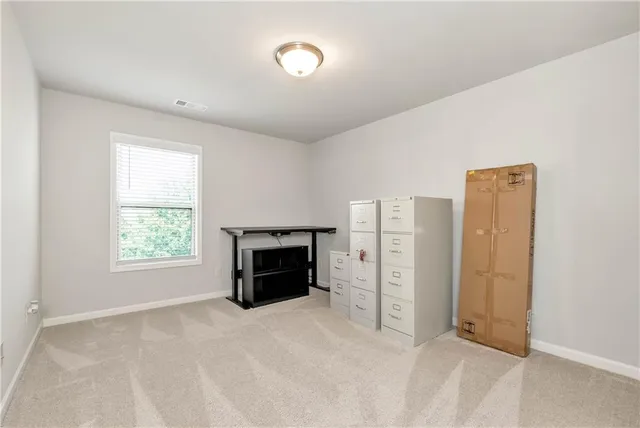 an empty room with furniture and a window