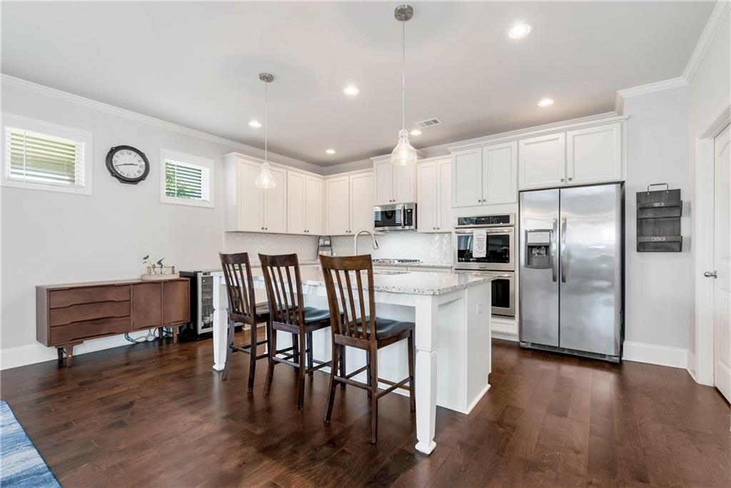 253 Orchard Trail Canton, GA 30115 - Photo 3 of 40 a kitchen with granite countertop a refrigerator and wooden floors