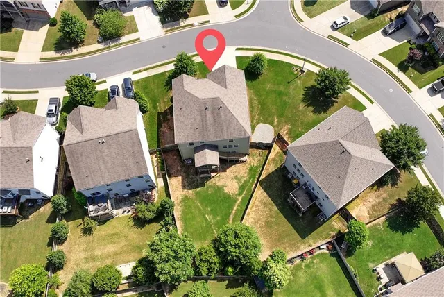 an aerial view of a house with yard swimming pool and outdoor seating
