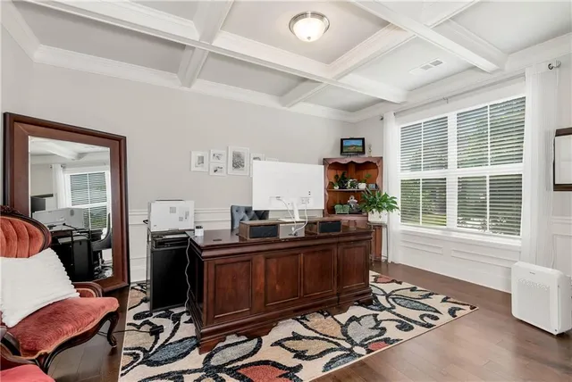 a view of a workspace with furniture and a window