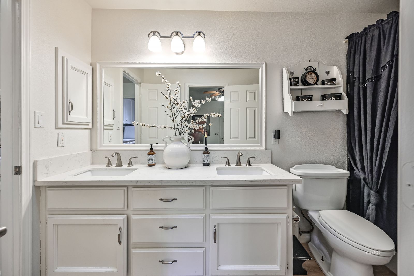 1213 Joshua Court Ridgecrest, CA 93555 - Photo 28 of 50 a bathroom with a toilet sink and mirror