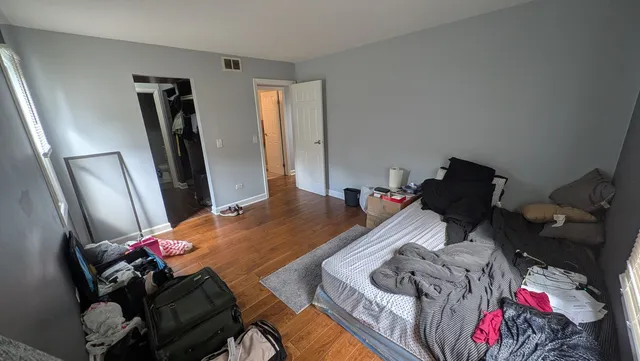 a bedroom with bed and a mirror