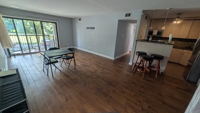 a dining room with furniture and wooden floor