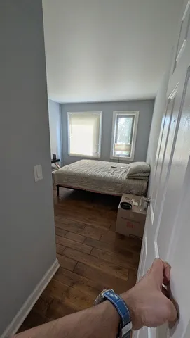 a bedroom with a bed and window