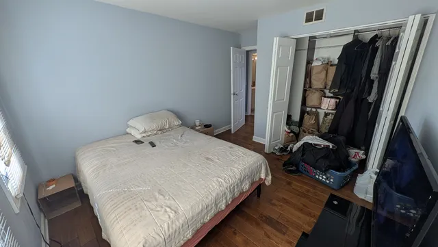 a bedroom with a bed and a window