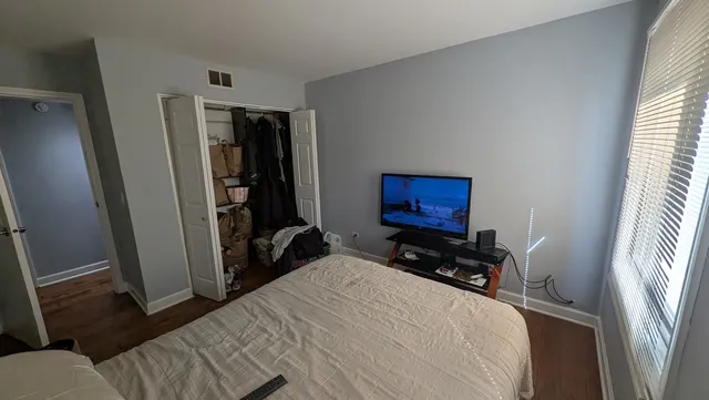 a bedroom with a bed and a window