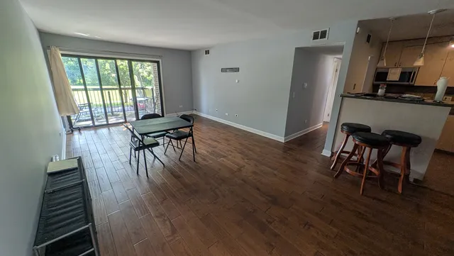 a view of a dining room with furniture window and wooden floor