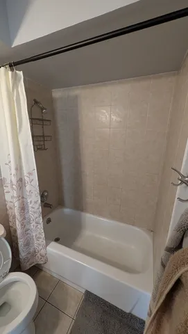 a bathroom with a double vanity sink toilet and shower