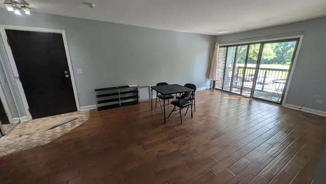 a view of a livingroom with furniture wooden floor and a window