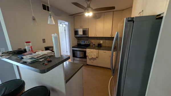 a kitchen with stainless steel appliances a refrigerator stove and sink