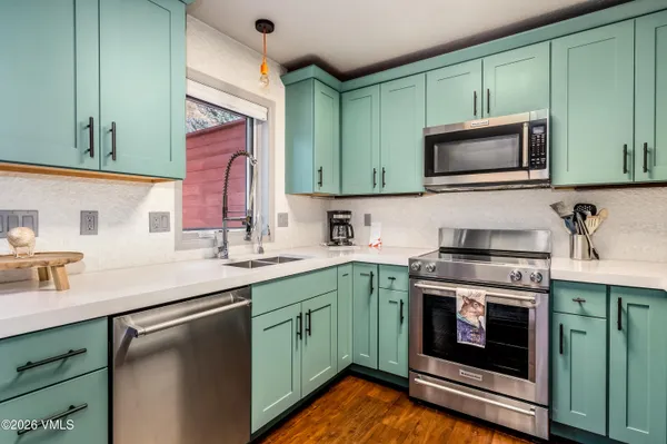a kitchen with a sink stove and microwave